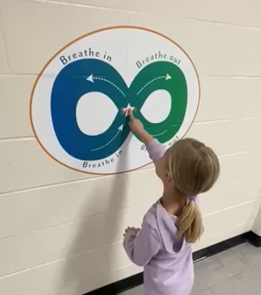 child doing sensory infinity wall graphic